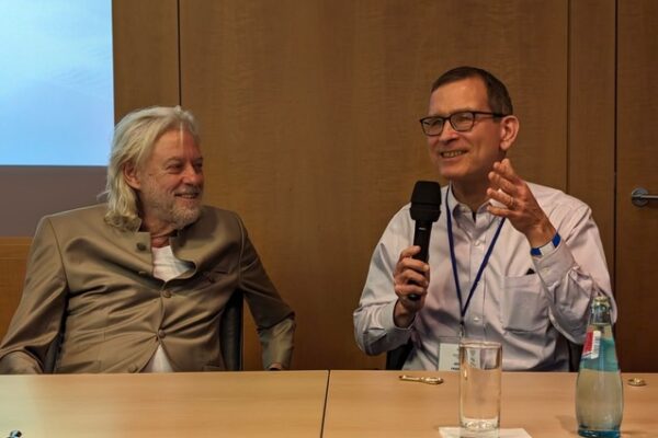 Bruce Friedrich and Bob Geldof on a panel at the 2024 World Forum on the Future of Democracy, Tech and Humankind